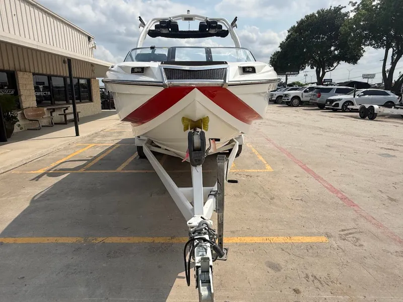 Slide: The Image of 2019 Centurion Ri257 boat on trailer in front of building. - 13