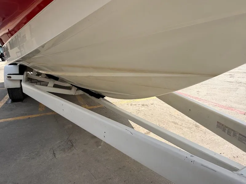Slide: The Image of 2019 Centurion Ri257 boat parked on a trailer. - 14
