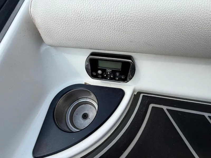 Slide: The Image of 2019 Centurion Ri257 boat dashboard with cup holder and control panel. - 20