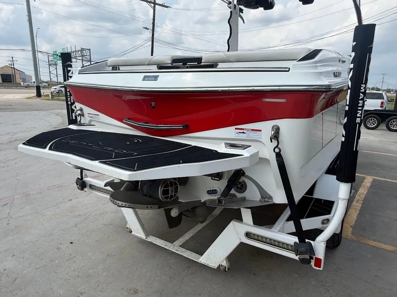 Slide: The Image of Red 2019 Centurion Ri257 boat parked in a lot. - 8