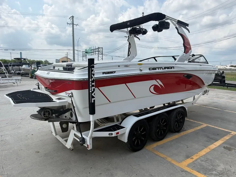 Slide: The Image of 2019 Centurion Ri257 boat on trailer, red and white design. - 9
