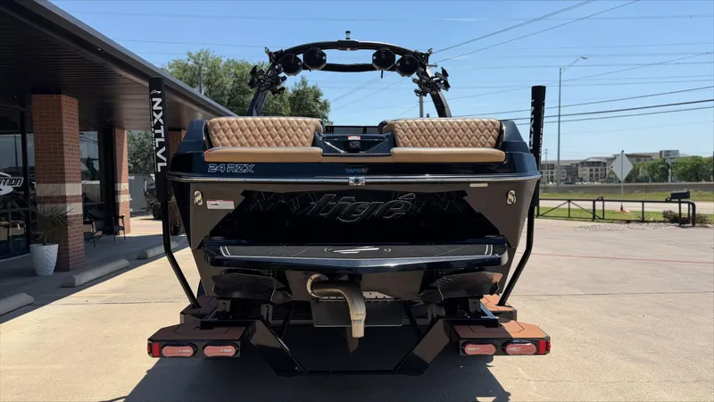 Slide: The Image of Rear view of 2024 Tigé 24RZX boat on a parking lot. - 4