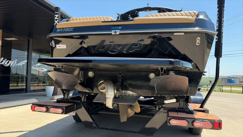 Slide: The Image of Rear view of 2024 Tigé 24RZX boat on a trailer. - 5
