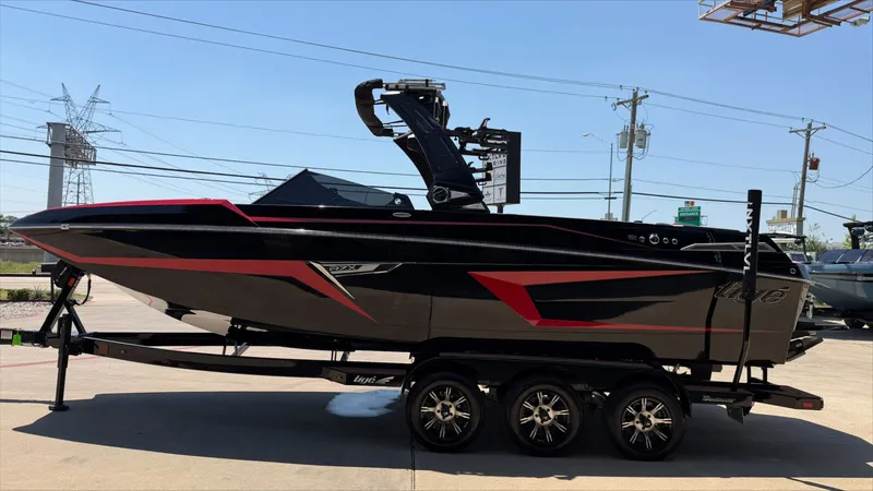 Slide: The Image of 2024 Tigé 24RZX boat on trailer, black and red design. - 6