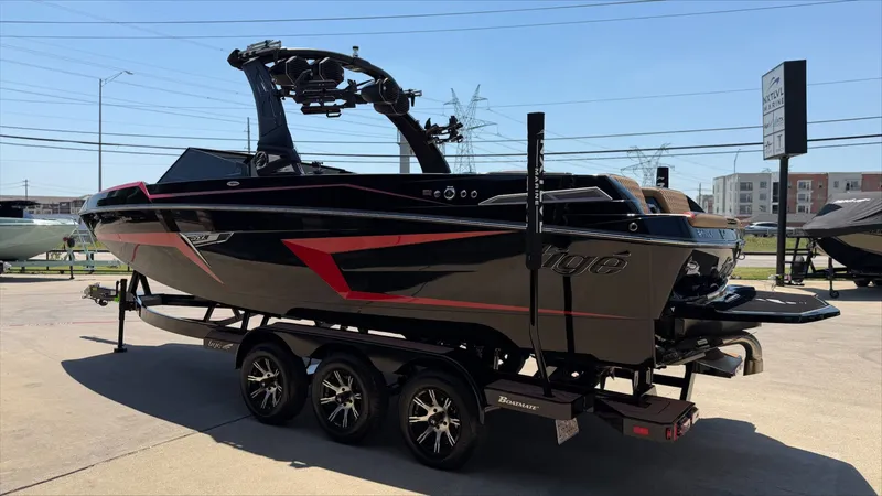 Slide: The Image of 2024 Tigé 24RZX boat on trailer outdoors. - 7