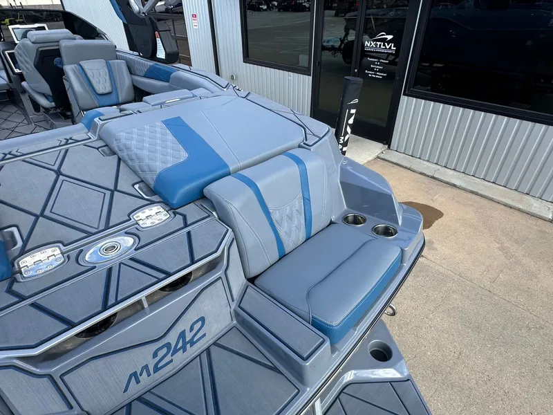 Slide: The Image of 2024 Malibu M242 boat with luxurious blue interior. - 12