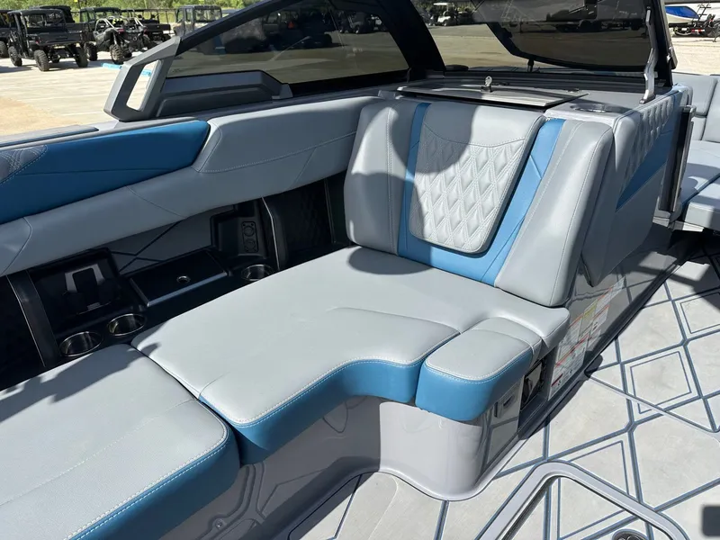 Slide: The Image of Interior of 2024 Malibu M242 boat with blue and gray seating. - 15