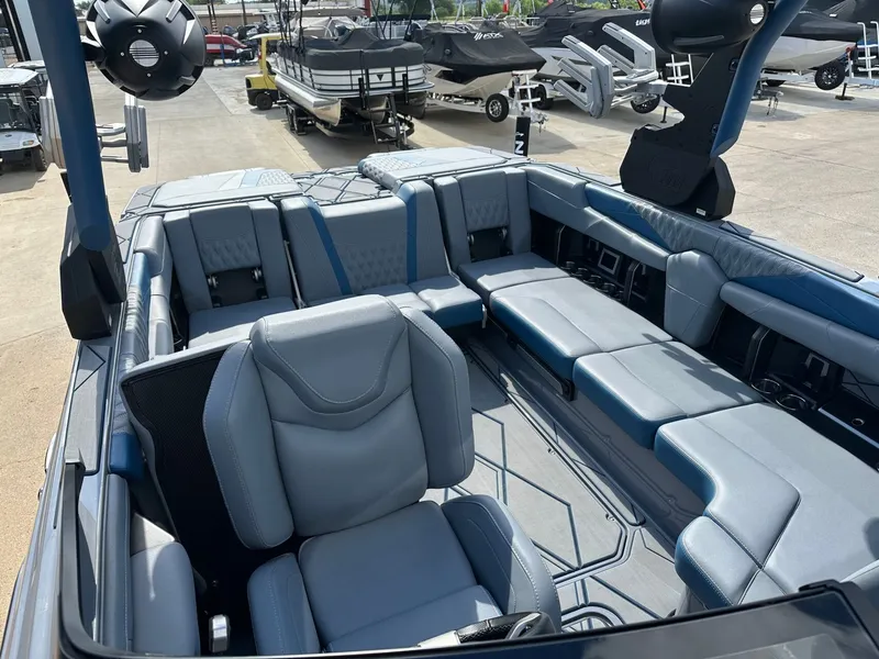 Slide: The Image of Interior of 2024 Malibu M242 boat with luxurious blue seating. - 26