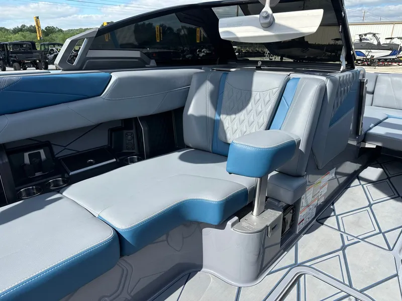 Slide: The Image of Interior of 2024 Malibu M242 boat with blue and gray seating. - 36