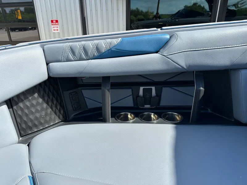 Slide: The Image of 2024 Malibu M242 interior with blue upholstery and cup holders. - 41