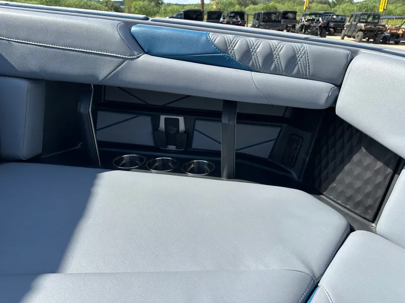Slide: The Image of 2024 Malibu M242 interior with blue accents and cup holders. - 43