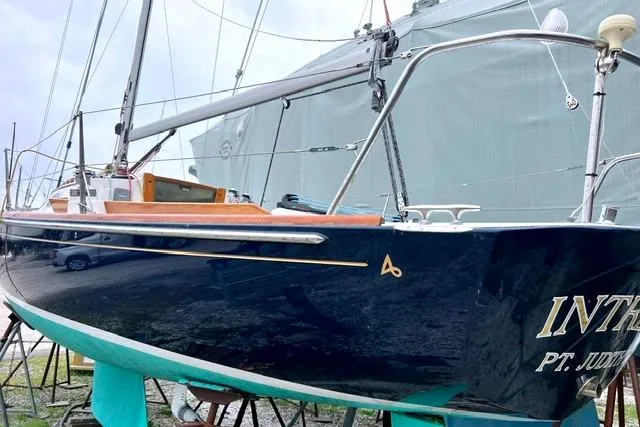 Slide: The Image of 2007 Alerion Express 28 sailboat on stands, featuring sleek design and dark hull. - 2