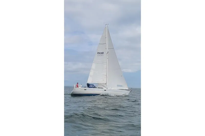The Image of Sailing yacht Catalina 36 MkII, 1996 model, cruising on open water under cloudy skies. - 0