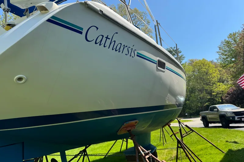 Slide: The Image of Catalina 36 MkII sailboat named "Catharsis" on land, with a truck nearby, 1996 model. - 14