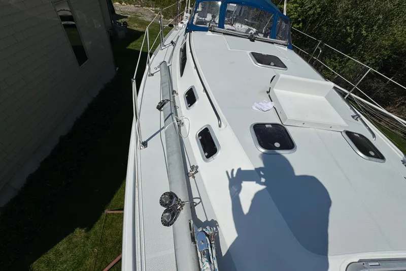 Slide: The Image of Catalina 36 MkII sailboat deck, 1996 model, with hatches and railing in sunlight. - 17