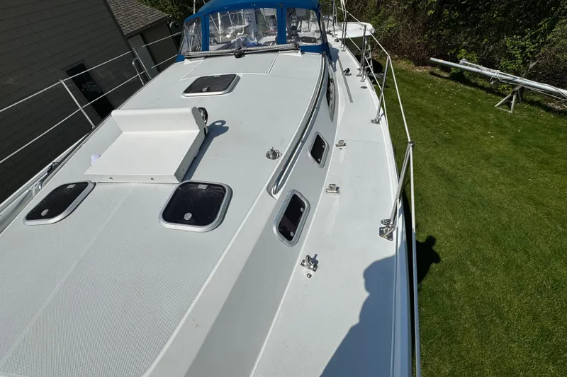 Slide: The Image of Catalina 36 MkII 1996 sailboat deck with hatches and railing, docked on grass. - 18