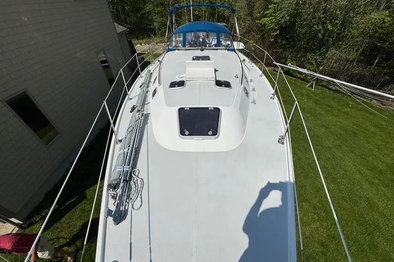 Slide: The Image of Catalina 36 MkII sailboat deck, 1996 model, viewed from above, surrounded by greenery. - 19