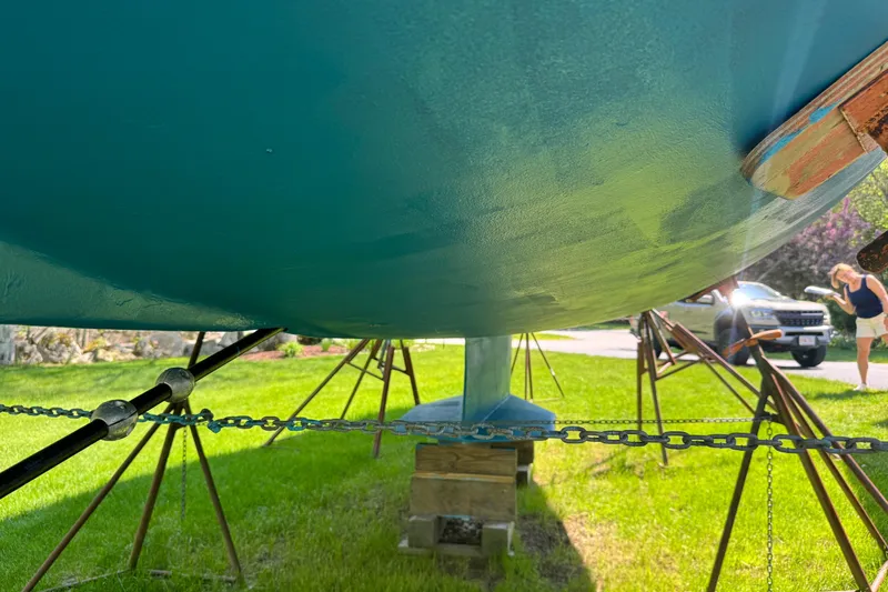 Slide: The Image of Underneath view of a 1996 Catalina 36 MkII sailboat on stands in a grassy yard. - 20
