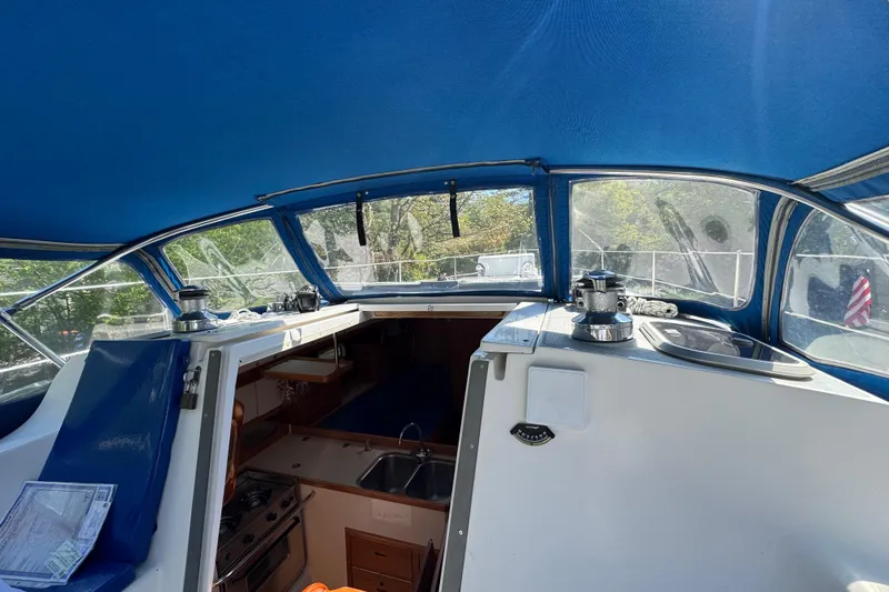 Slide: The Image of Interior view of a 1996 Catalina 36 MkII sailboat with blue canopy and kitchen area. - 26