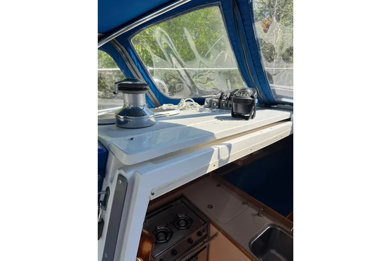 Slide: The Image of Interior view of a 1996 Catalina 36 MkII sailboat, featuring a winch and navigation equipment. - 27