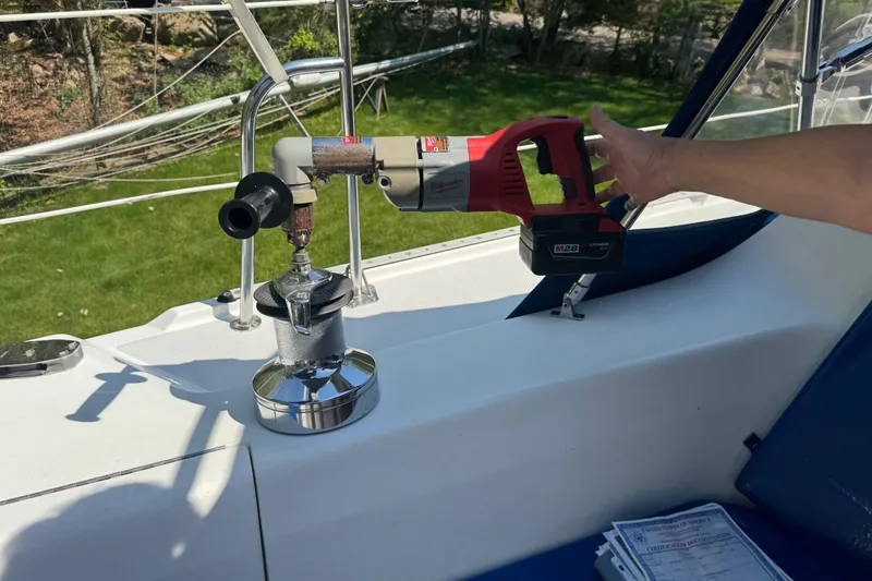 Slide: The Image of Hand operating a power tool on a 1996 Catalina 36 MkII sailboat deck. - 28
