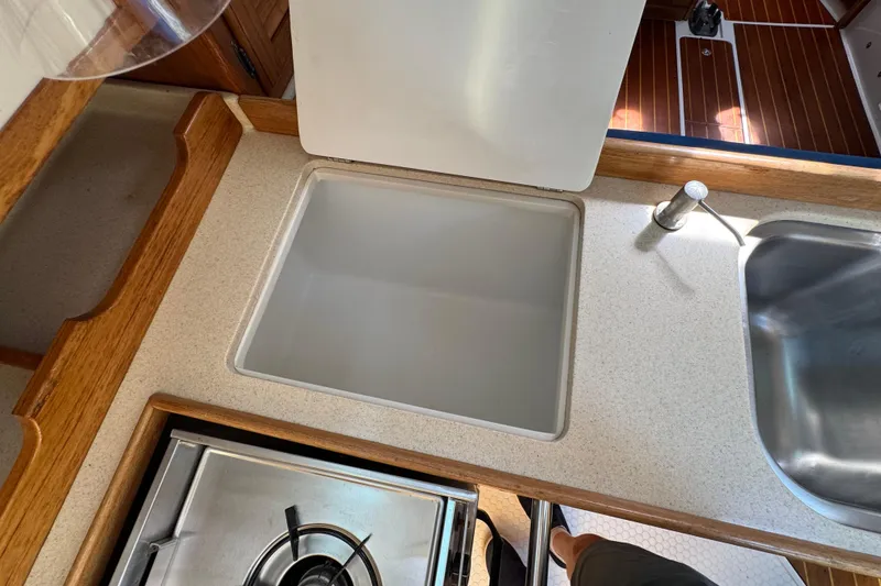 Slide: The Image of Interior view of a 1996 Catalina 36 MkII yacht kitchen with stove and sink. - 37