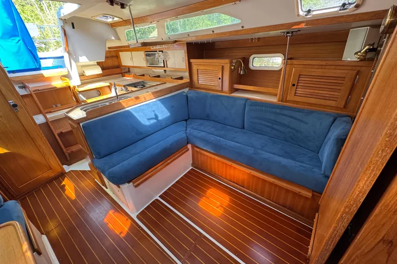 Slide: The Image of Interior of a 1996 Catalina 36 MkII sailboat with blue seating and wooden finishes. - 39