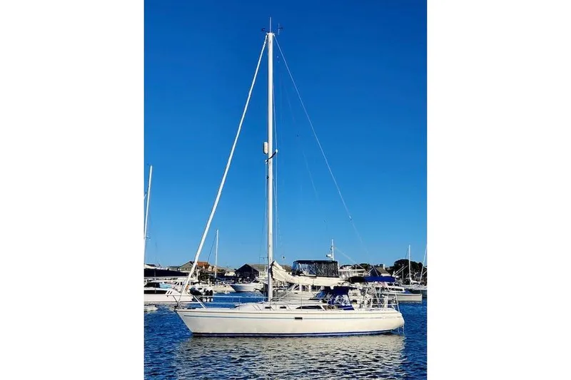 Slide: The Image of 1996 Catalina 36 MkII sailboat docked in a marina under clear blue skies. - 4