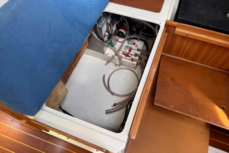Slide: The Image of Open compartment in 1996 Catalina 36 MkII sailboat showing plumbing and wiring. - 50