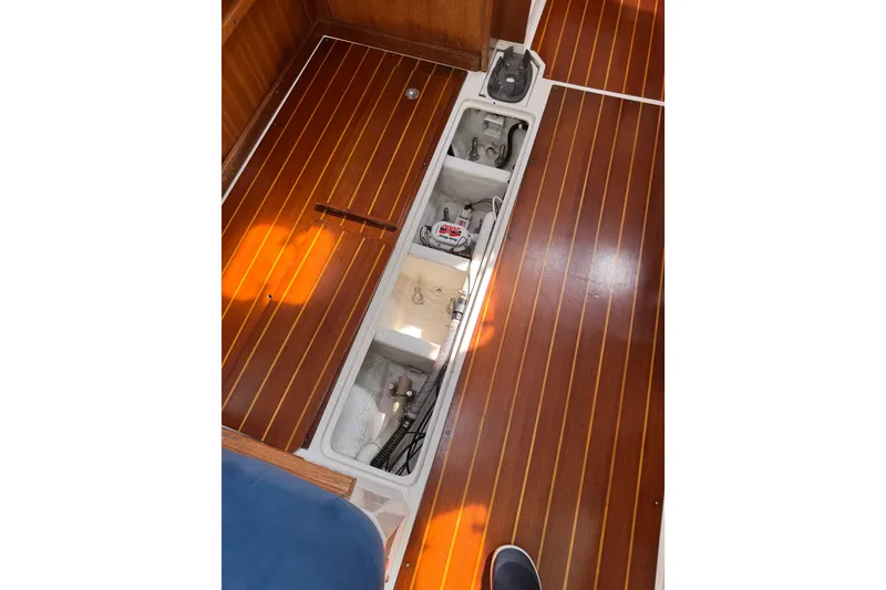 Slide: The Image of Wooden floor with open hatch revealing Catalina 36 MkII boat components. - 53