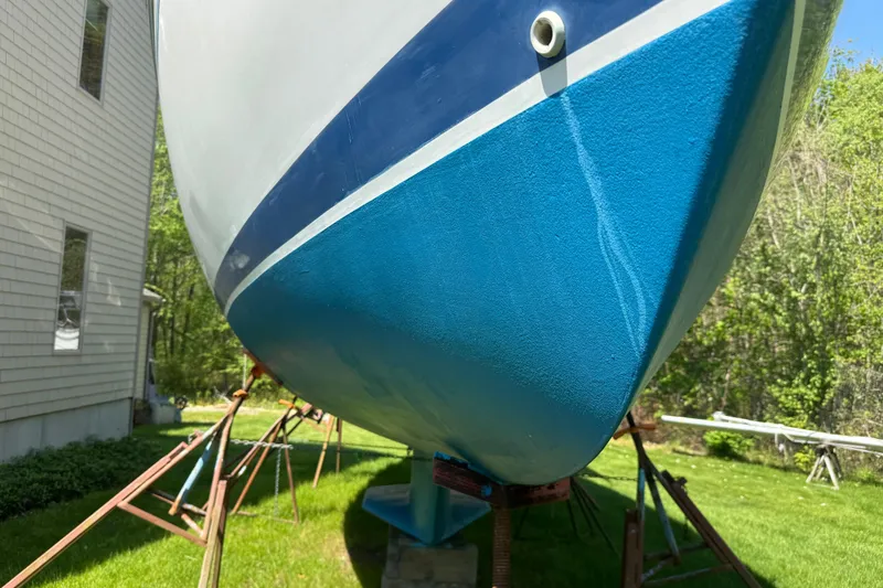 Slide: The Image of Catalina 36 MkII sailboat from 1996 on stands, vibrant blue hull, sunny day. - 6