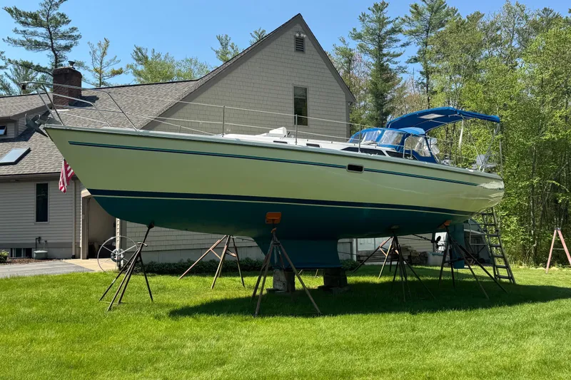 Slide: The Image of 1996 Catalina 36 MkII sailboat on stands in a grassy yard near a house. - 7