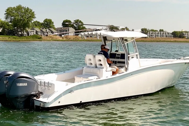 The Image of 2018 Cape Horn 31 T boat with dual Yamaha engines on a calm lake. - 1