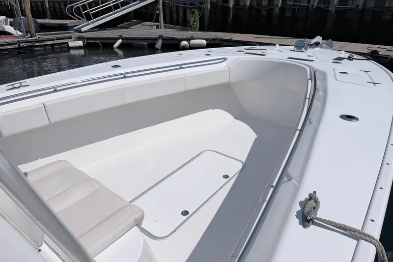 Slide: The Image of 2018 Cape Horn 31 T boat interior with white seating at dock. - 10