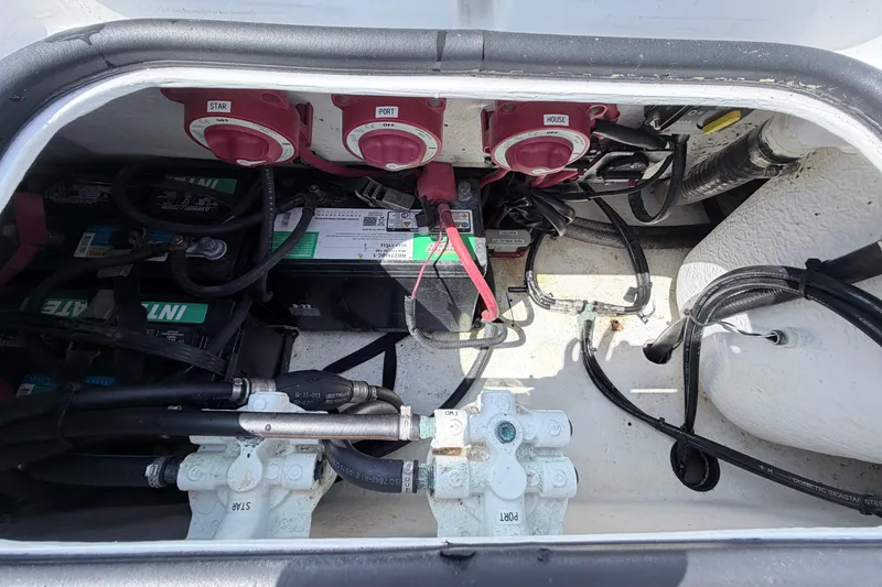 Slide: The Image of Battery compartment of a 2018 Cape Horn 31 T boat, showing wiring and switches. - 12