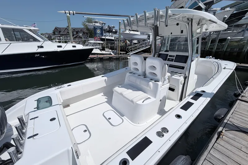 Slide: The Image of 2018 Cape Horn 31 T boat docked, featuring spacious seating and modern controls. - 6