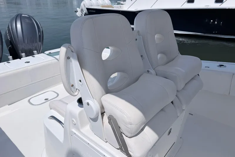 Slide: The Image of 2018 Cape Horn 31 T boat with dual white cushioned seats and Yamaha engines. - 8