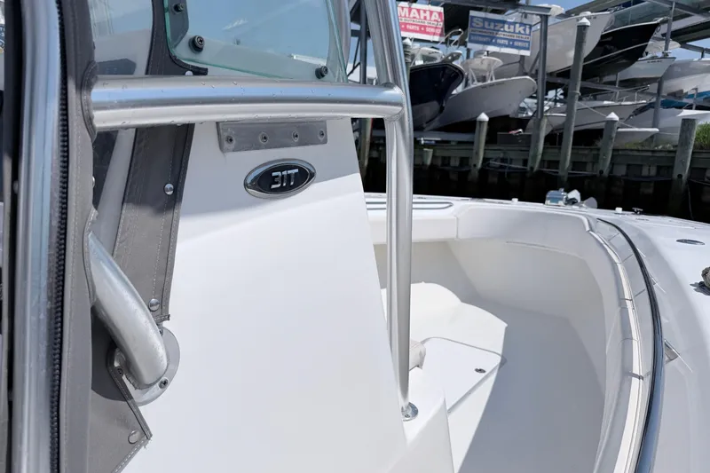 Slide: The Image of 2018 Cape Horn 31 T boat, featuring sleek design and sturdy railing at a marina. - 9