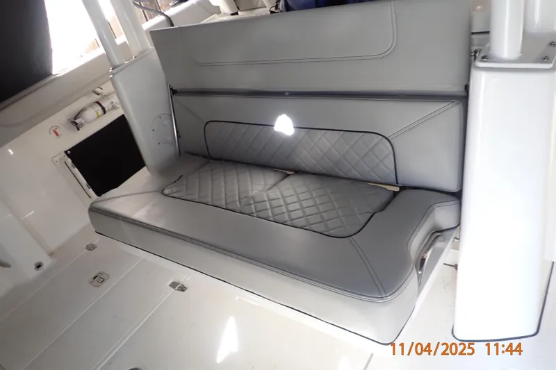 Slide: The Image of 2023 Pursuit S 328 Sport boat interior with gray cushioned seating. - 10
