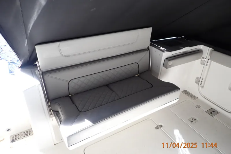 Slide: The Image of 2023 Pursuit S 328 Sport boat interior with cushioned seating and storage compartments. - 11