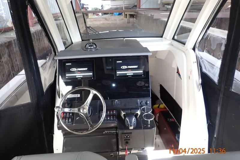 Slide: The Image of 2023 Pursuit S 328 Sport boat cockpit with dual displays and modern controls. - 3