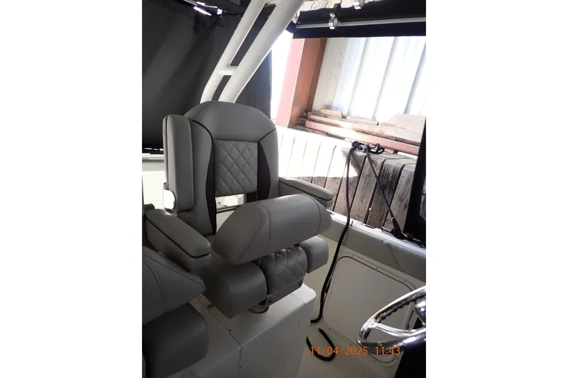 Slide: The Image of Captain's chair in 2023 Pursuit S 328 Sport boat, featuring sleek, modern design. - 4