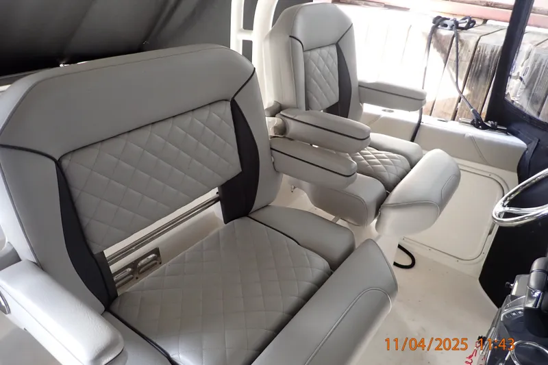 Slide: The Image of 2023 Pursuit S 328 Sport boat interior with luxurious gray seating. - 6