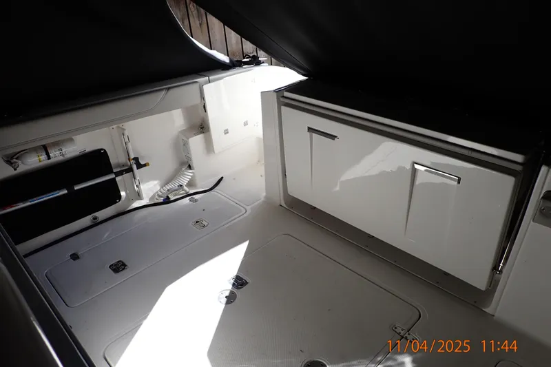 Slide: The Image of Interior view of 2023 Pursuit S 328 Sport boat, showcasing storage compartments. - 9