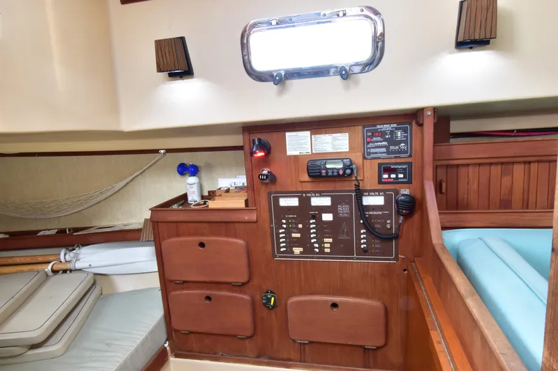 Slide: The Image of 1994 Island Packet 32 sailboat interior with control panel and cozy cabin features. - 10