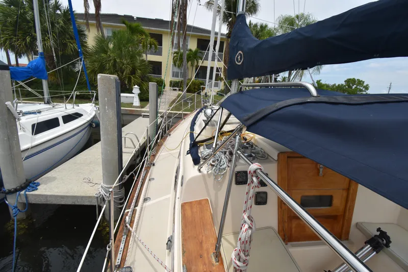 Slide: The Image of 1994 Island Packet 32 sailboat docked, featuring deck and rigging details. - 2