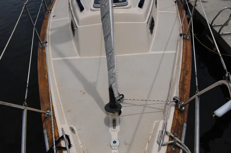 Slide: The Image of 1994 Island Packet 32 sailboat deck with rigging and wooden trim at dock. - 4