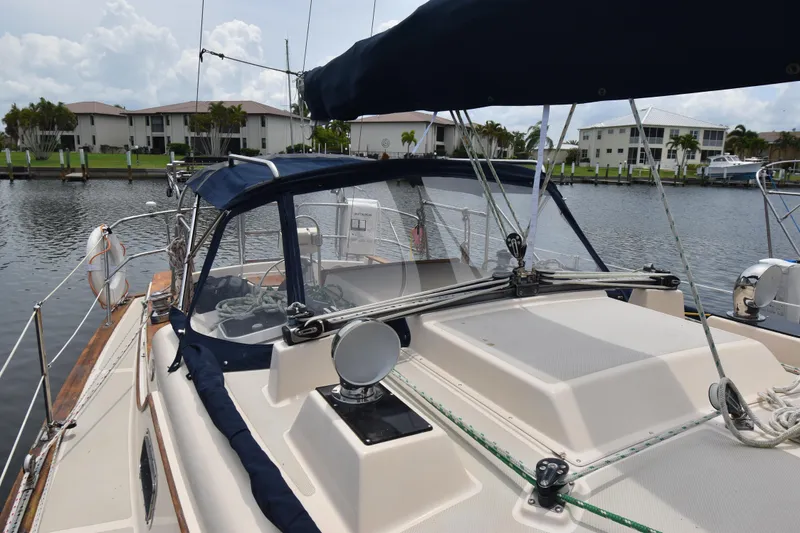 Slide: The Image of 1994 Island Packet 32 sailboat docked in a serene marina setting. - 5