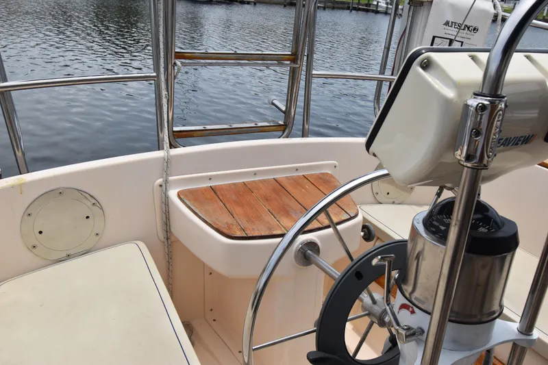 Slide: The Image of Cockpit of 1994 Island Packet 32 sailboat with wooden seating and steering wheel. - 6