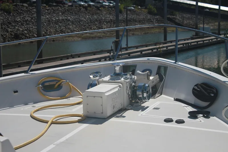 Slide: The Image of Bow deck of 1999 Grand Alaskan Pilothouse yacht with anchor winch and coiled rope. - 100